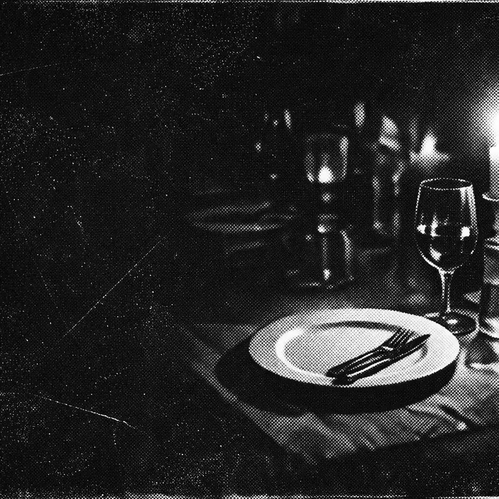 Candlelit dining table in deep shadow with a single illuminated plate