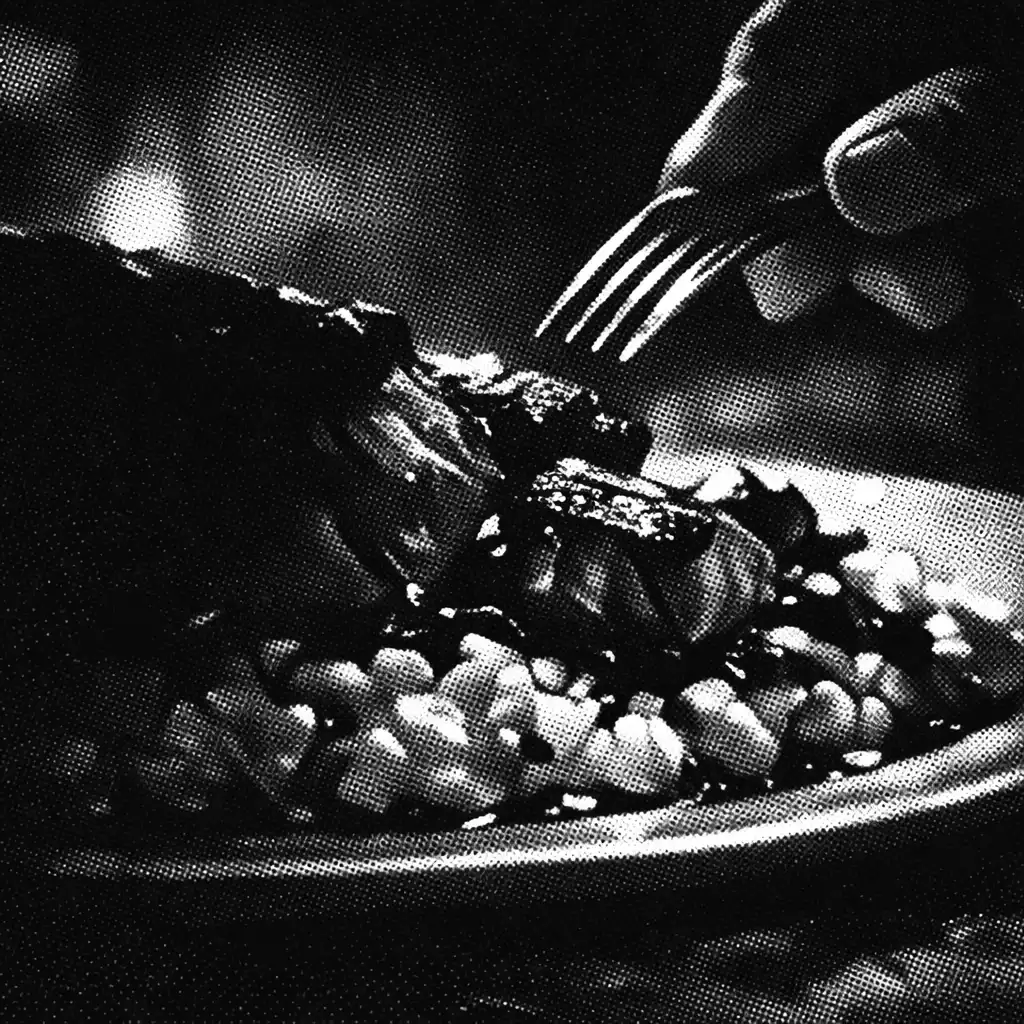 Close-up of a shadowed plated dish with dramatic lighting