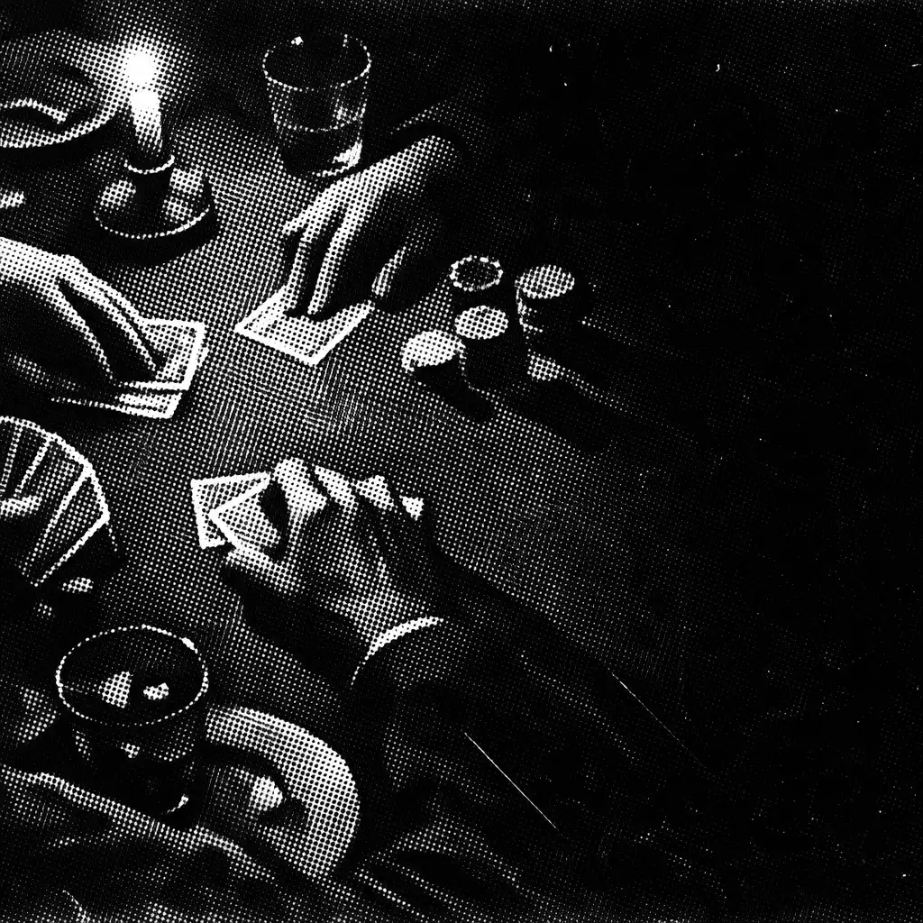 Hands dealing cards at a candlelit poker table
